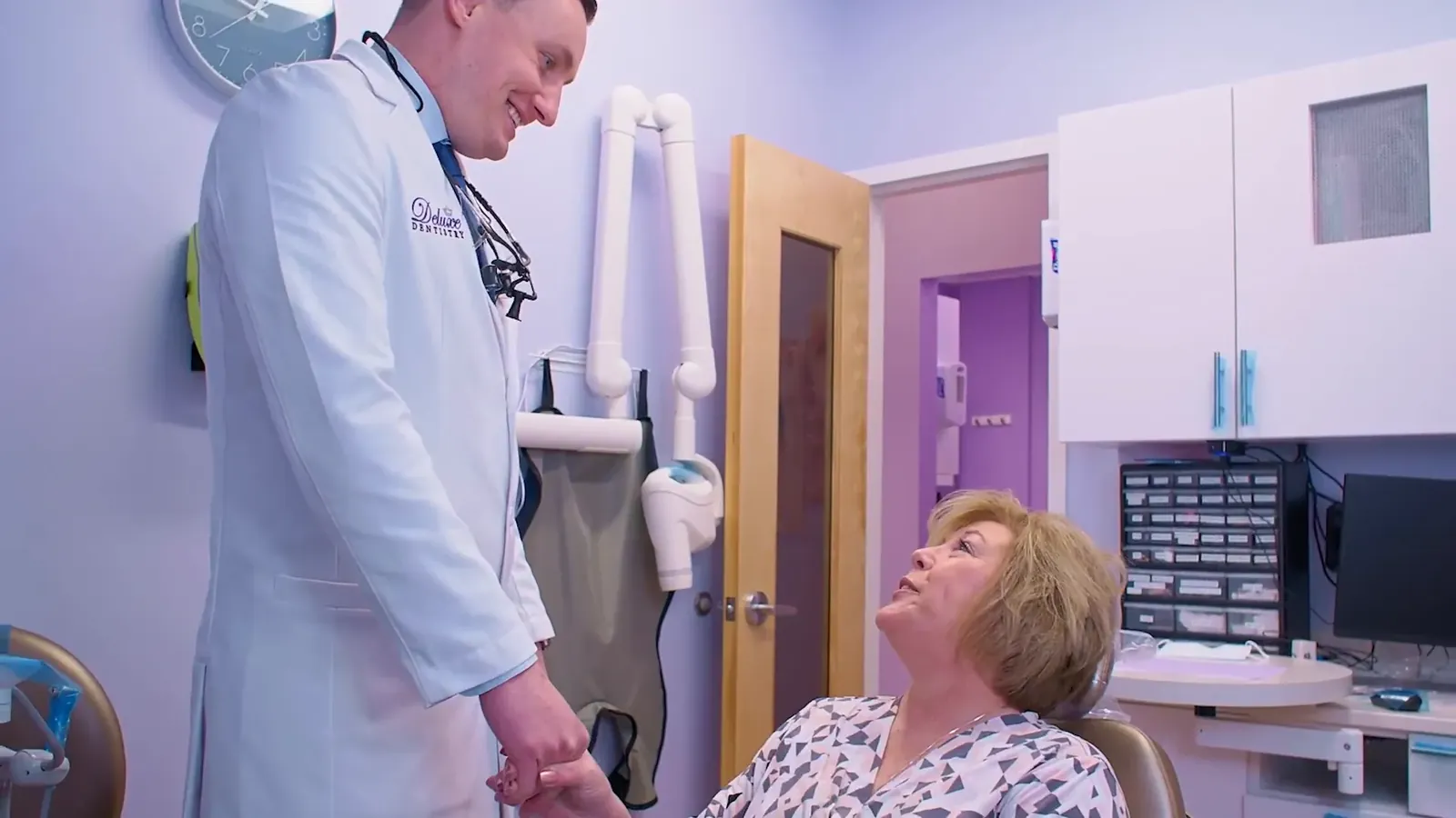 Dr. Godko reassuring a patient in the treatment chair